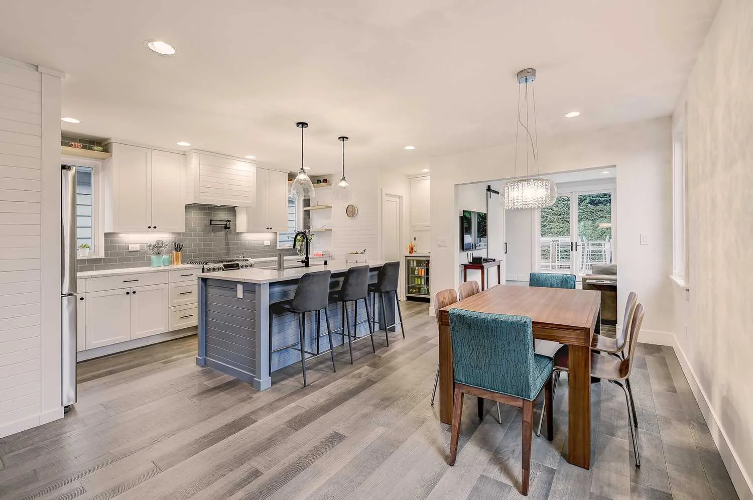 Two-tone cabinets refinished by Hedlund Painting in a Green Lake, Seattle kitchen: kitchen opening into the dining area.