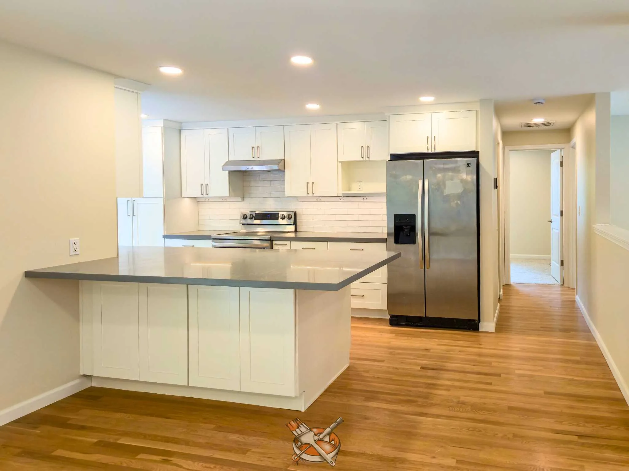 Warm-white cabinets refinished by Hedlund Painting in a Kirkland kitchen remodel