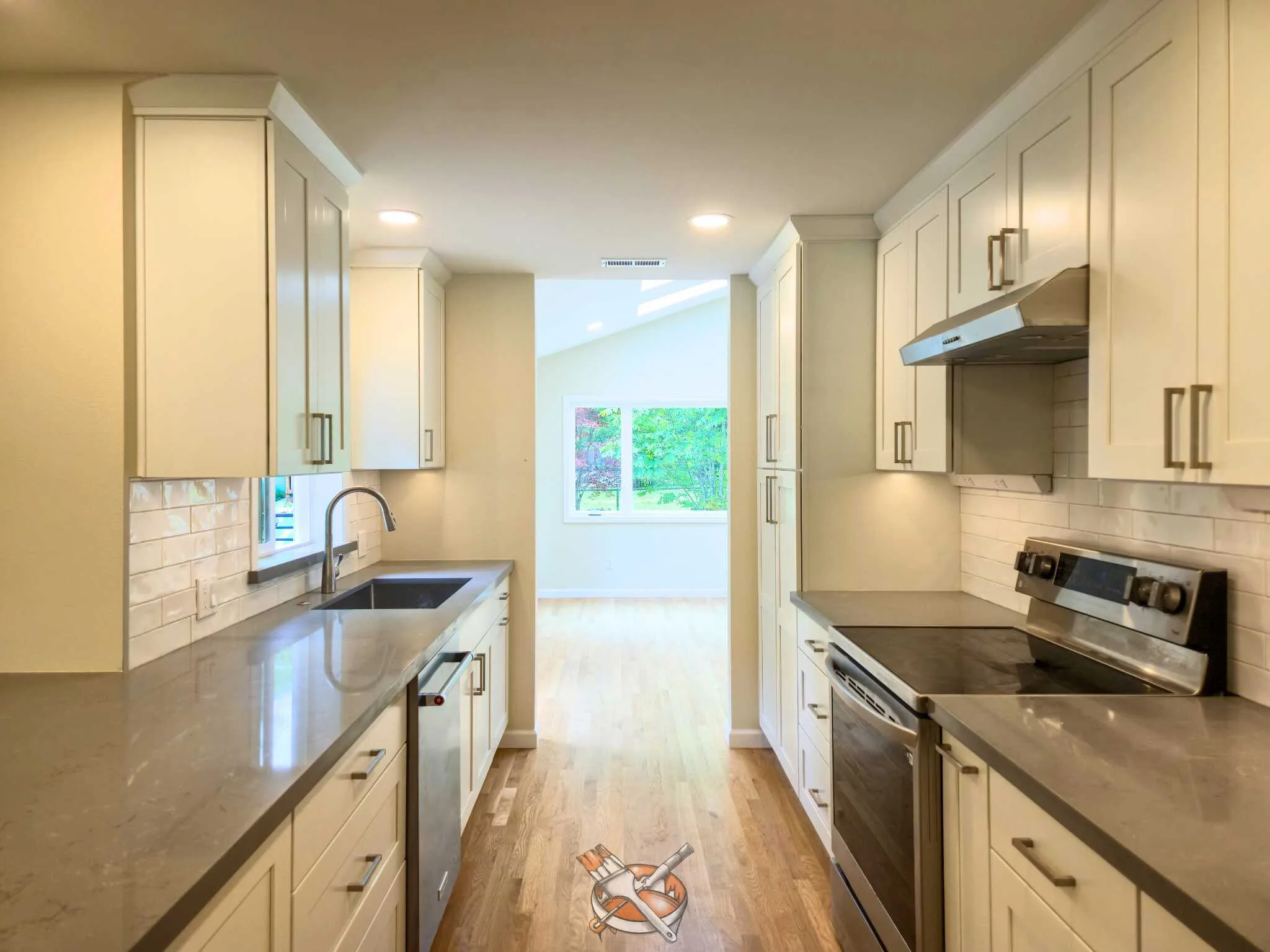 Warm-white cabinets refinished by Hedlund Painting in a Kirkland kitchen remodel