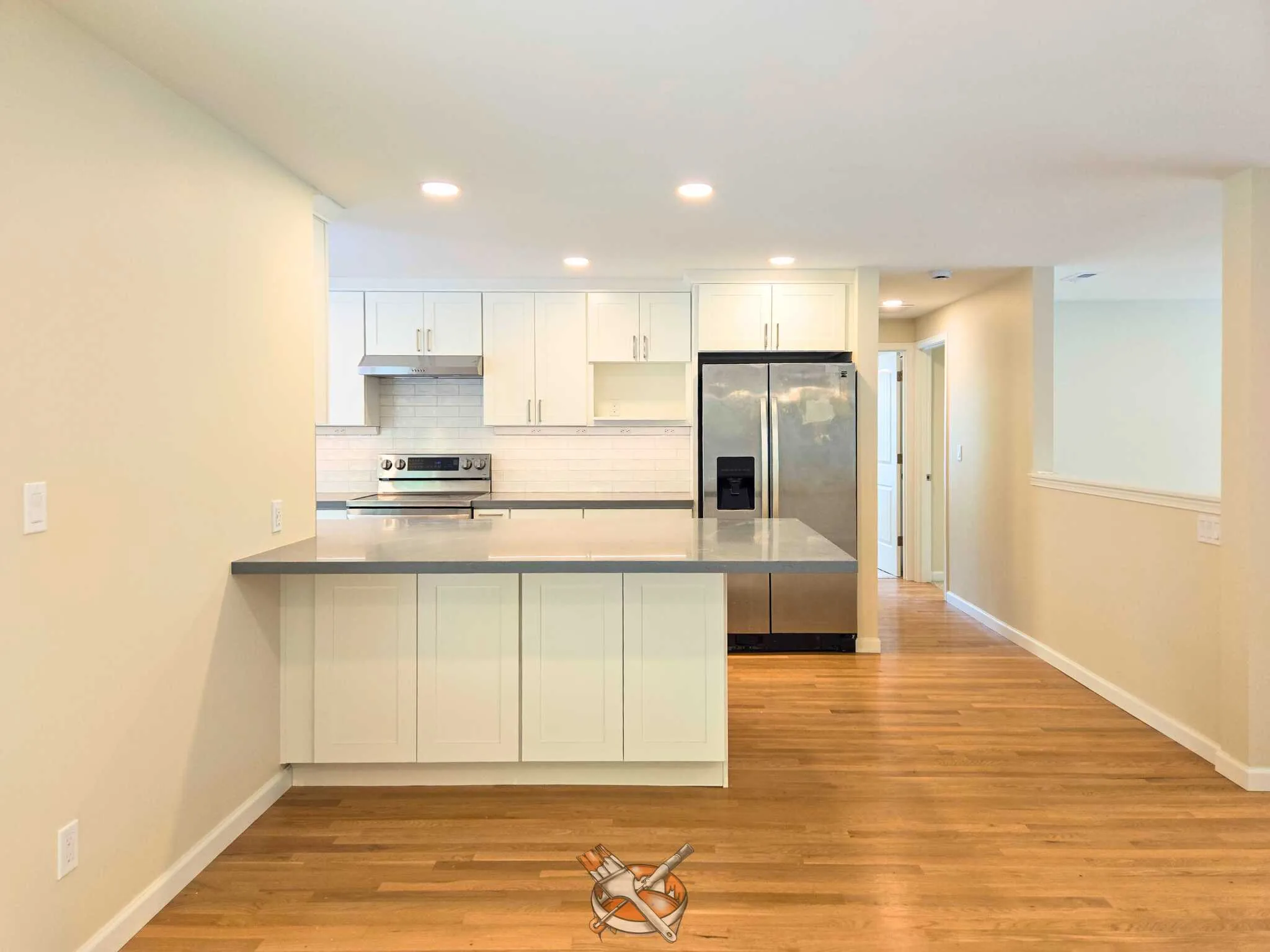 Warm-white cabinets refinished by Hedlund Painting in a Kirkland kitchen remodel